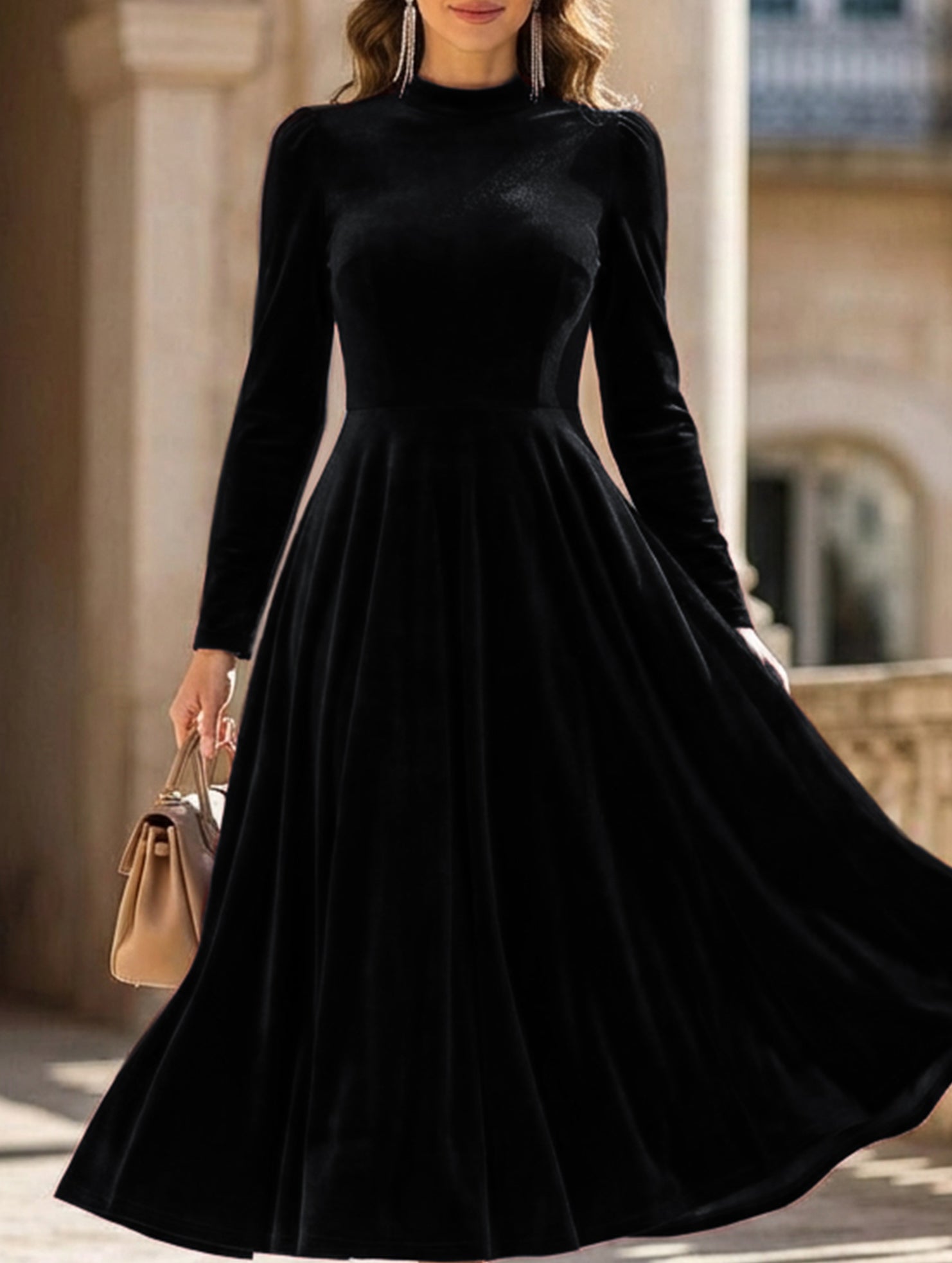 Black velvet long-sleeved round neck dress by Tammy Bradley, showcasing a sleek, fitted design with a smooth fabric finish.