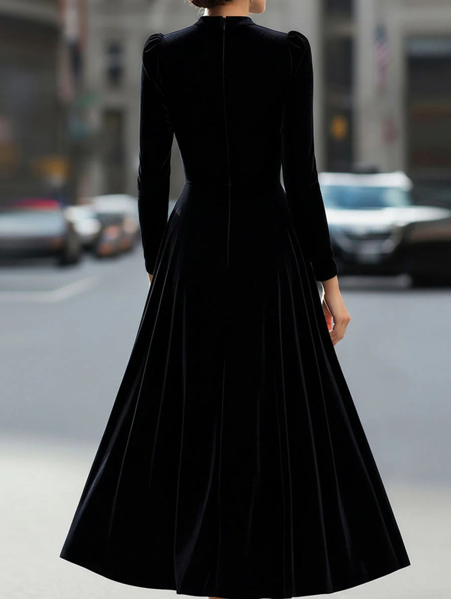 Black velvet round neck long-sleeved dress by Tammy Bradley, shown on a hanger against a plain background.