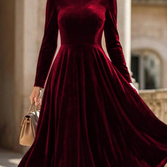 White velvet round neck long-sleeved dress by Tammy Bradley, shown on a model with a fitted silhouette and elegant design.