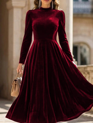 White velvet round neck long-sleeved dress by Tammy Bradley, shown on a model with a fitted silhouette and elegant design.