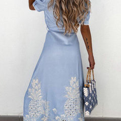 White pastoral style openwork embroidered dress with delicate detailing, perfect for elegant occasions.
