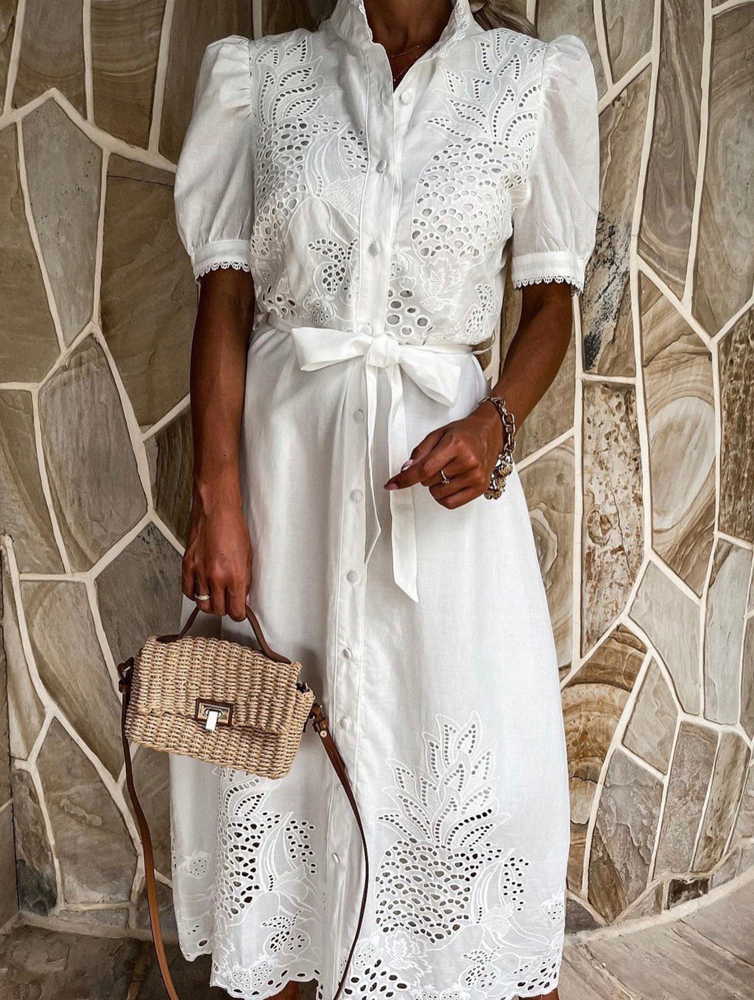 White pastoral style openwork embroidered dress featuring intricate embroidery and a flowing design, perfect for casual or formal wear.