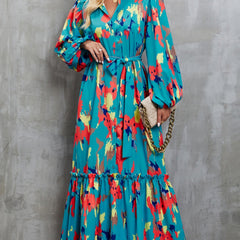 Blue printed tie-waist lantern sleeve dress with a white background, showcasing a stylish and flowy design.