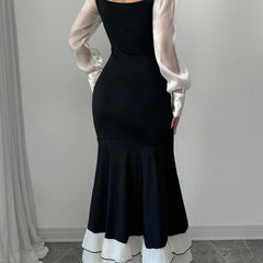 Black colorblock long sleeve mermaid dress by My Store, featuring a fitted silhouette and stylish design.