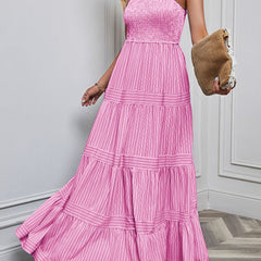 Pink retro striped maxi dress with a fitted bodice and flowing skirt, perfect for casual or summer wear.