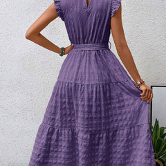 White ruffled flutter sleeve tie textured dress, stylish and feminine, featuring a relaxed fit and elegant design.
