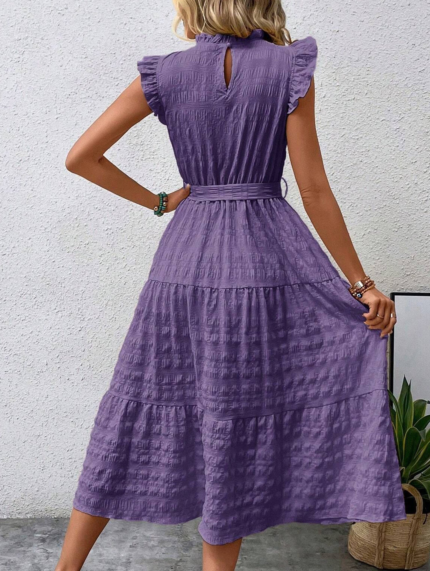 White ruffled flutter sleeve tie textured dress, stylish and feminine, featuring a relaxed fit and elegant design.