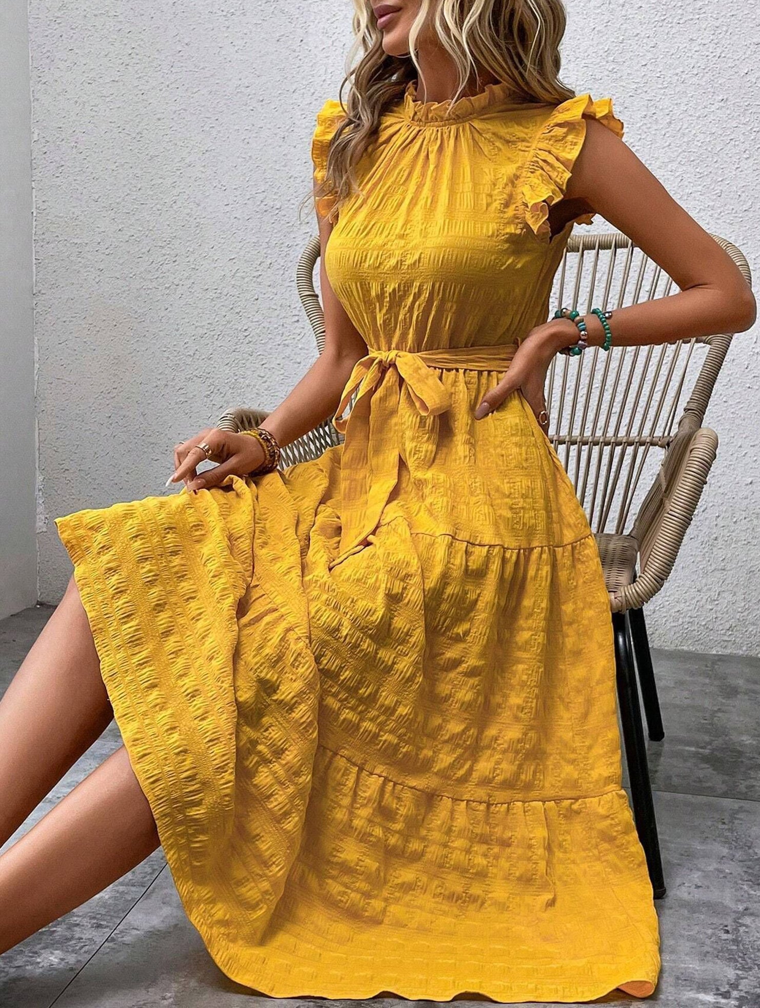White ruffled flutter sleeve tie dress with textured fabric, stylish and comfortable, perfect for casual or semi-formal wear.