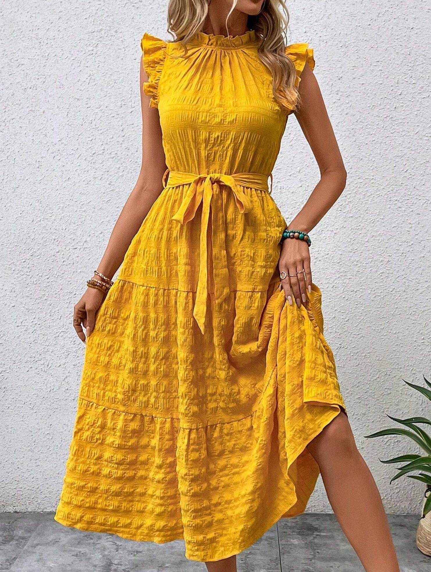 Yellow ruffled flutter sleeve tie textured dress, stylish and feminine, featuring a fitted waist and flowy skirt.