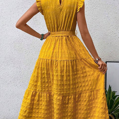 White ruffled flutter sleeve tie textured dress with a flattering fit, perfect for casual or semi-formal occasions.