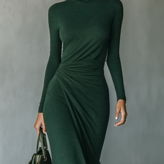 Dark green knit wrap midi dress for women, featuring long sleeves and a fitted waist, styled with a flowy skirt.