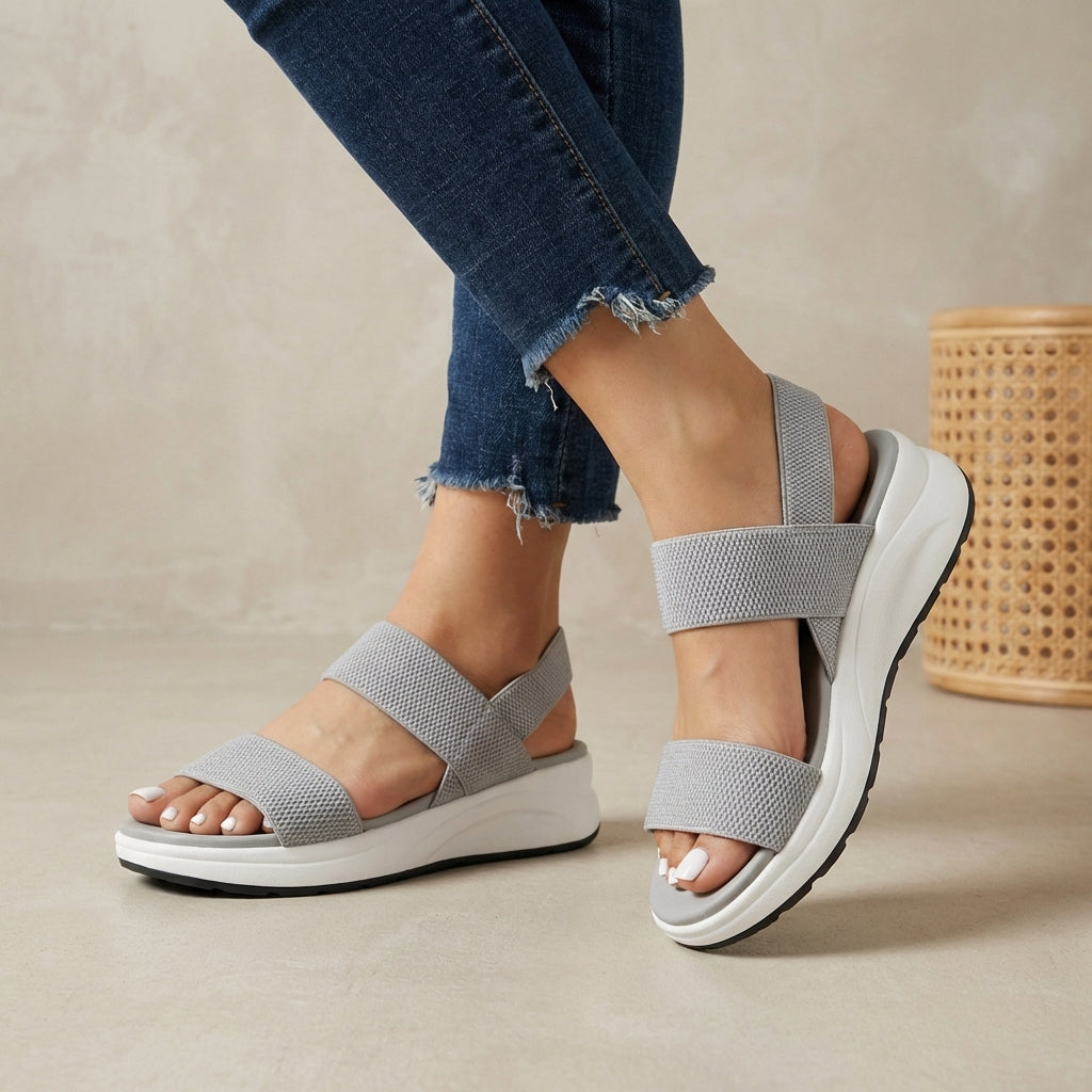 Gray women's orthopedic sandals with adjustable straps and flowy design, providing comfort and support.