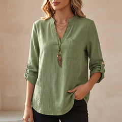 Green women's summer blouse with a V-neck, linen fabric, and flowy fit, perfect for warm weather and casual style.