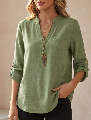 Green women's summer blouse with a V-neck, linen fabric, and flowy fit, perfect for warm weather and casual style.