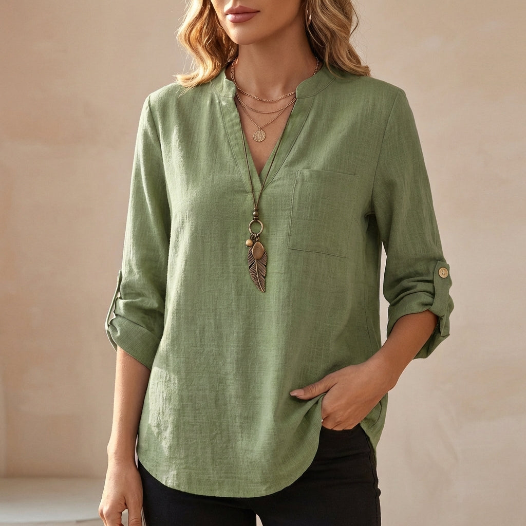 Green women's summer blouse with a V-neck, linen fabric, and flowy fit, perfect for warm weather and casual style.