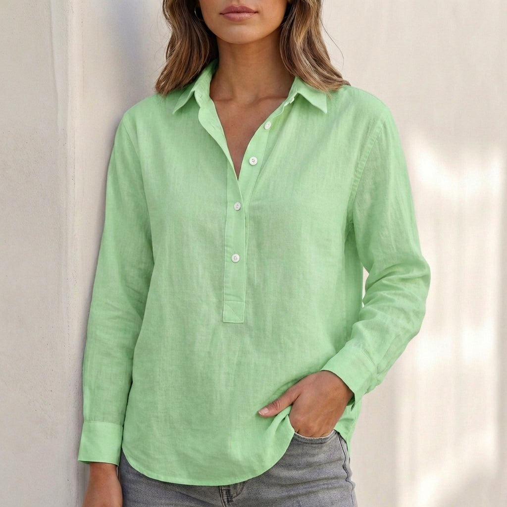 White linen V-neck relaxed-fit women's popover shirt by Tammy Bradley, shown in a green background with a casual style.