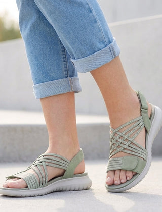 Green orthopedic criss-cross strappy women's sandals with adjustable straps for a comfortable fit.