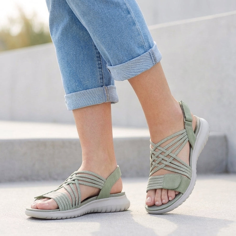 Green orthopedic criss-cross strappy women's sandals with adjustable straps for a comfortable fit.