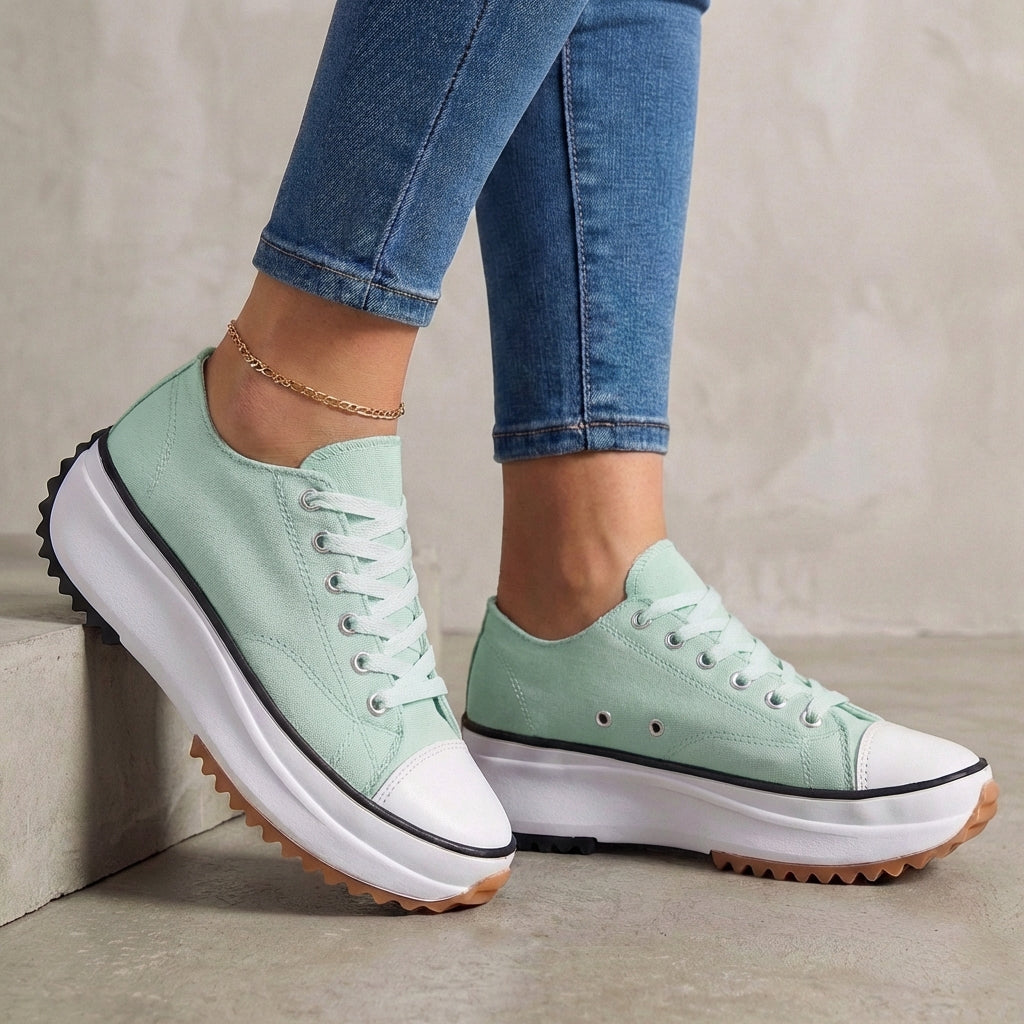 Green women's orthopedic sneakers with lace-up design, providing comfort and support in stylish athletic footwear.