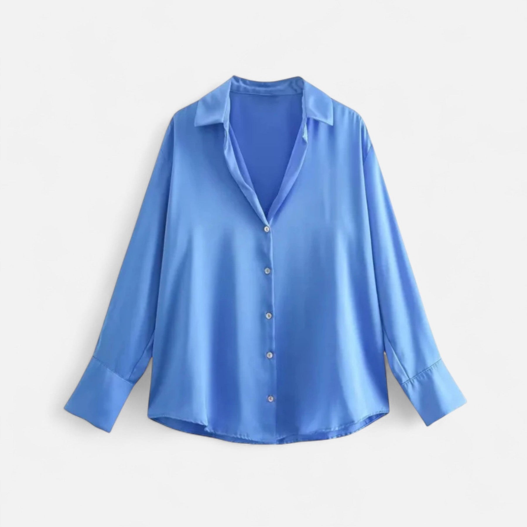Women's button-front long sleeve blouse in classic fit, light-colored fabric with a collar and button details.
