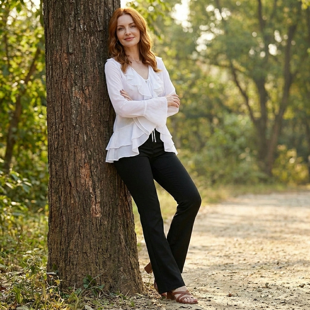 Women’s summer blouse in denim with bell sleeves, stylish casual top for warm weather, featuring a relaxed fit and feminine design.