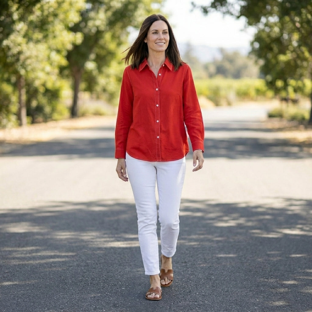 Light linen summer blouse for women with button front, casual top perfect for warm weather, styled in a relaxed outdoor setting.