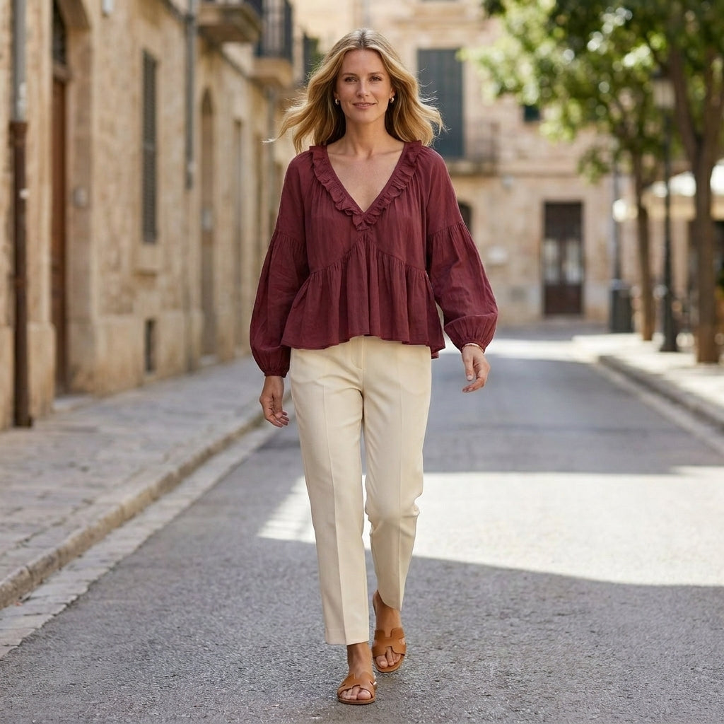 Women’s summer blouse with V-neck, long sleeves, and denim ruffle details, perfect for casual or stylish daytime wear.