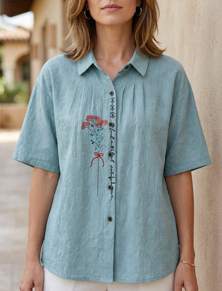 Light blue floral summer blouse for women with short sleeves, made of denim fabric, stylish and comfortable women's top.