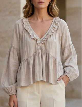 White V-neck long sleeve denim blouse with ruffle details, stylish women's top perfect for summer wear.