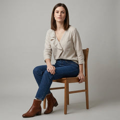 Women’s summer V-neck denim blouse with ruffle details, worn by a model showcasing casual stylish tops.