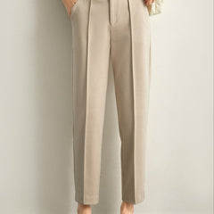 Women's Merino wool tapered trousers, stylish and comfortable pants for women, shown in a natural pose on a neutral background.