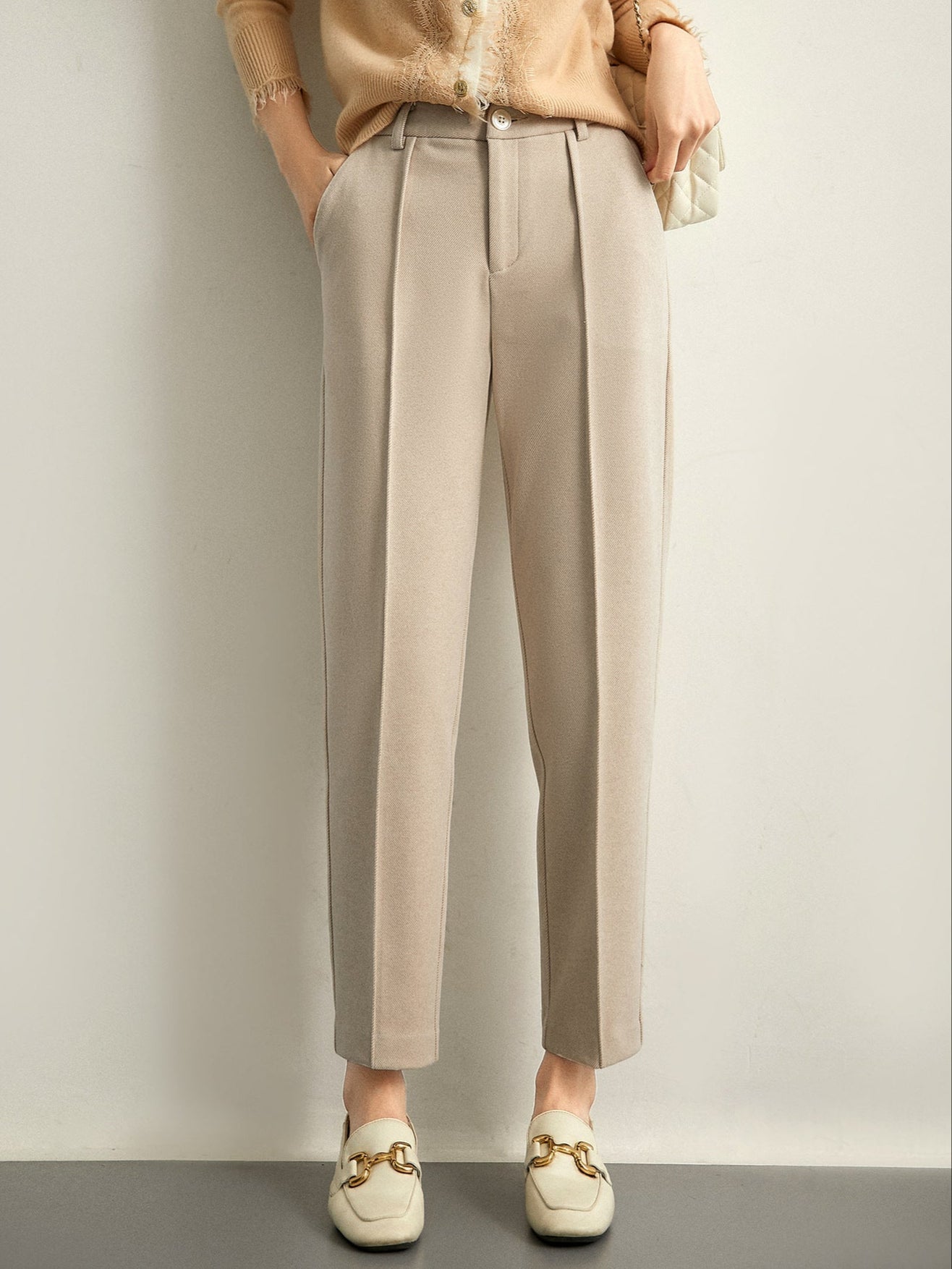 Women's Merino wool tapered trousers, stylish and comfortable pants for women, shown in a natural pose on a neutral background.