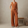 Orange women's linen pleated two-piece co-ord set by Tammy Bradley, featuring a stylish top and matching wide-leg pants.