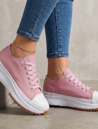 Pink women's orthopedic sneakers with lace-up design, providing comfort and support for active wear.