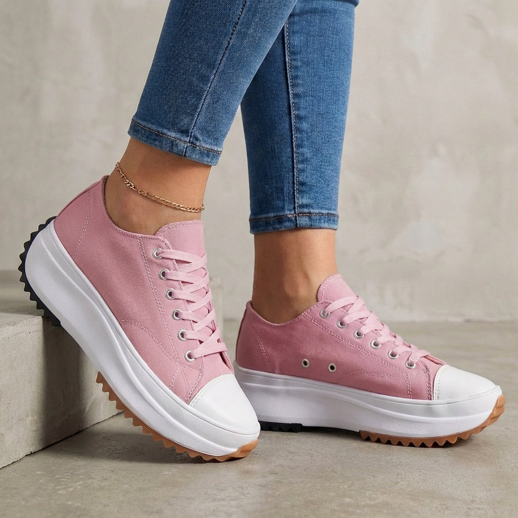 Pink women's orthopedic sneakers with lace-up design, providing comfort and support for active wear.