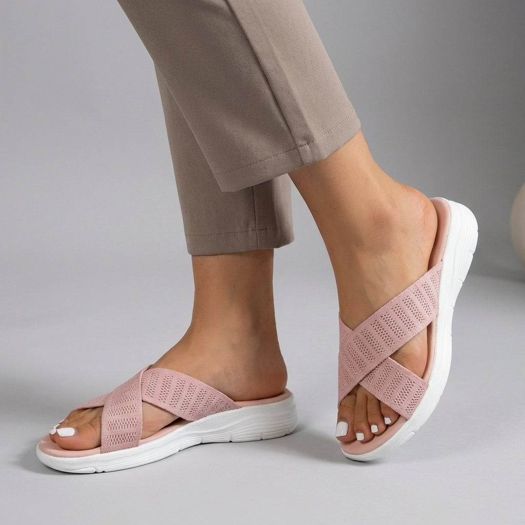 Pink Tammy Bradley criss-cross knit slide sandals for women, showcasing the stylish open-toe design and comfortable slip-on style.