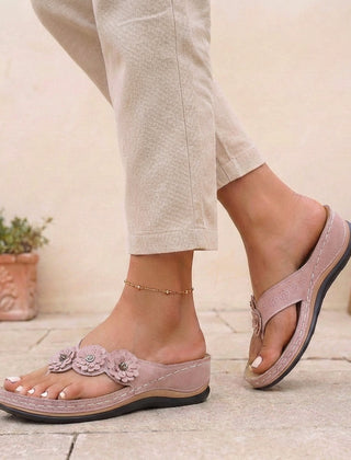 Pink floral appliqué wedge thong sandals for women by Tammy Bradley, featuring decorative flowers and comfortable wedge heel.