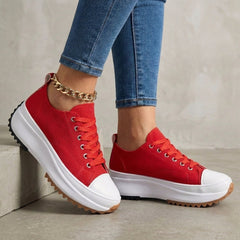 Red orthopedic women's sneakers with lace-up design, providing comfort and support for everyday wear.