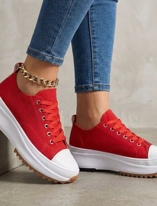 Red orthopedic women's sneakers with lace-up design, providing comfort and support for everyday wear.