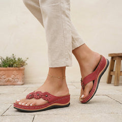 Red floral appliqué wedge thong sandals for women by Tammy Bradley, featuring decorative flower details and comfortable wedge heel.