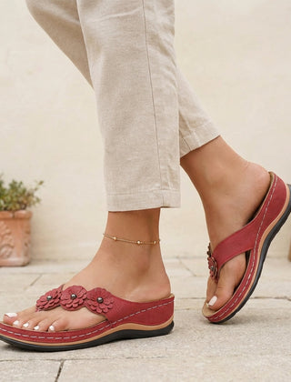 Red floral appliqué wedge thong sandals for women by Tammy Bradley, featuring decorative flower details and comfortable wedge heel.