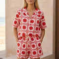 Red women's geometric high-waist two-piece set by Tammy Bradley, featuring a stylish crop top and matching high-waist pants.