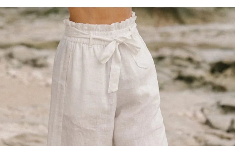 Linen wide-leg pull-on trousers for women, loose fit, breathable fabric, in neutral color, styled casually on a model.