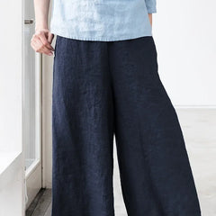 Linen cropped wide-leg drawstring trousers for women, loose pull-on style, light and breathable fabric, in neutral color.