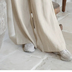 Linen wide-leg trousers for women, loose pull-on pants with relaxed fit, beige color, and soft fabric, perfect for casual wear.