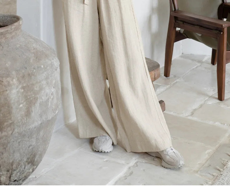 Light beige linen wide-leg trousers for women with a loose pull-on design, relaxed fit, and comfortable style.
