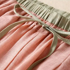 Light beige tapered linen trousers for women, featuring a loose pull-on design and relaxed fit, ideal for casual wear.