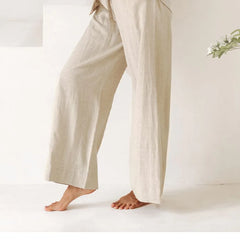 Light beige linen wide-leg trousers for women, loose pull-on style, showcasing relaxed fit and comfortable design.