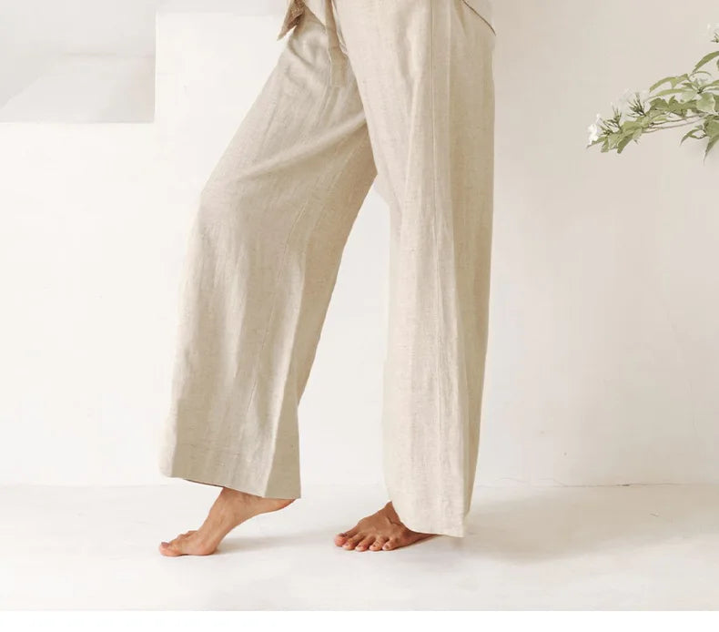 Light beige linen wide-leg trousers for women, loose pull-on style, showcasing relaxed fit and comfortable design.