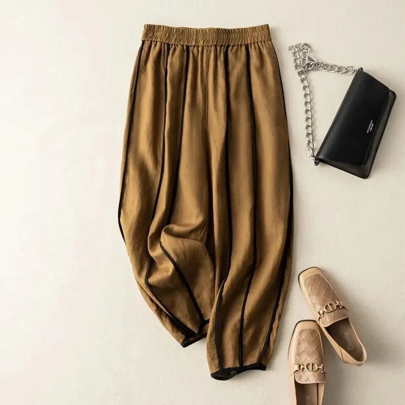 Linen wide-leg elastic-waist trousers for women, loose pull-on pants with a relaxed fit, in neutral fabric and stylish design.
